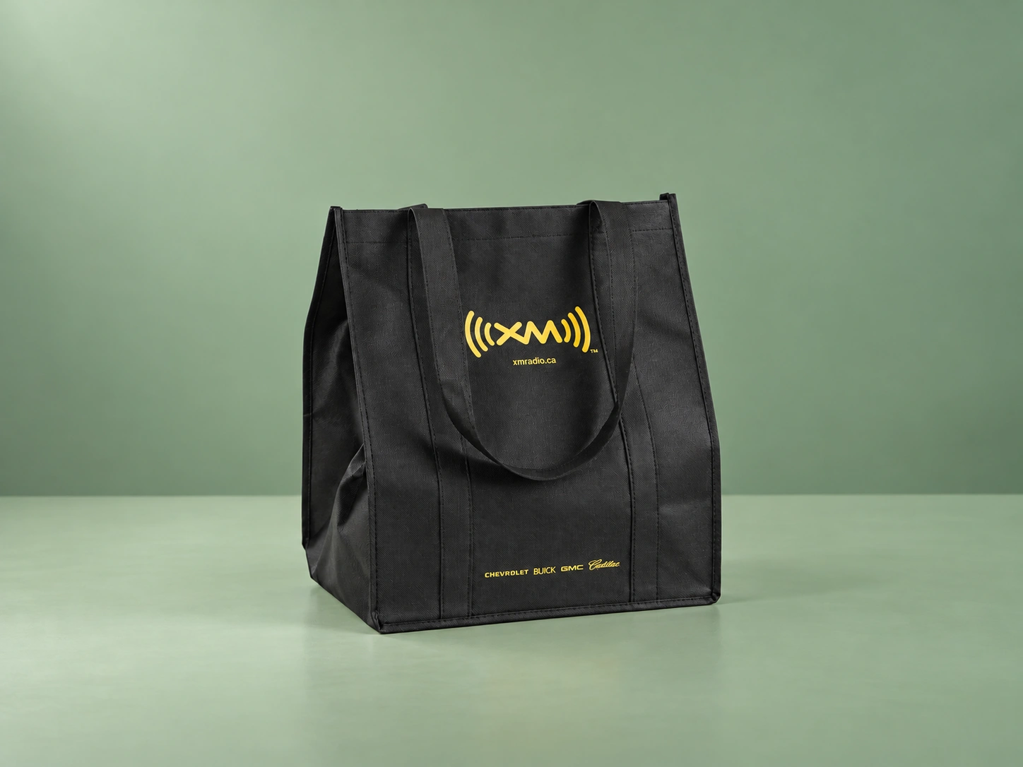 Black reusable tote bag with a yellow SiriusXM logo and short handles