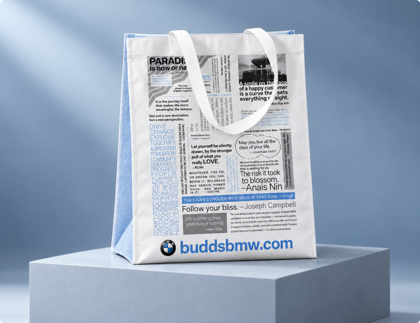 White Budds' BMW laminated shopping bag with blue and black print on a display plinth