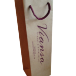 Tall custom paper wine bag with burgundy rope handles and matching printed branding