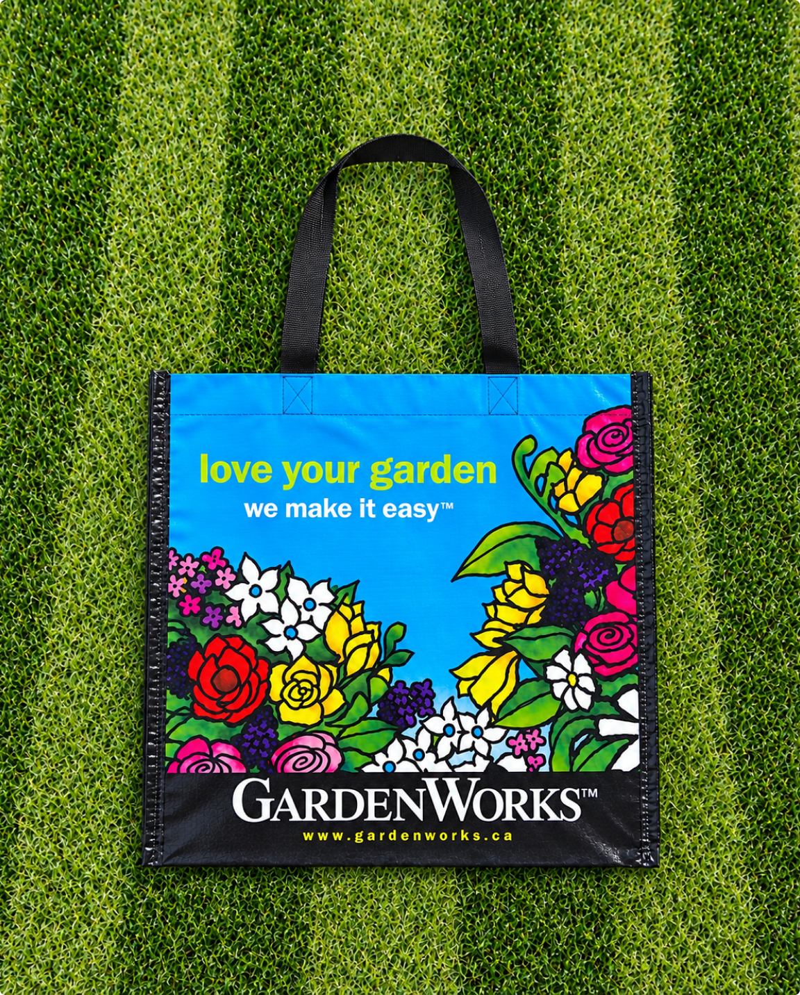 Colourful GardenWorks woven shopping bag with floral printing and black handles
