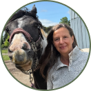 Icegreen founder outdoors beside a horse