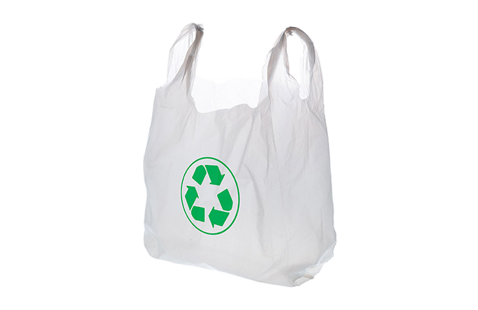 White shopping bag with loop handles and a green recycling symbol